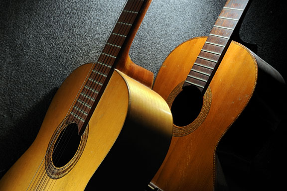 acoustic guitars on a dark surface