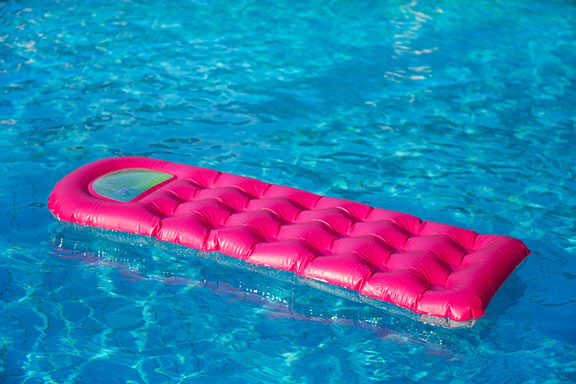 pink air mattress on blue water