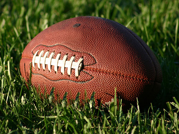 oval-shaped football with white laces