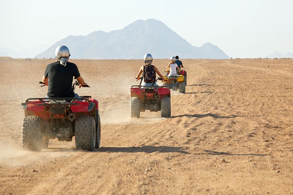 atv riders in the desert