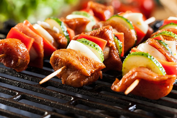 grilling with skewers on a barbecue grill