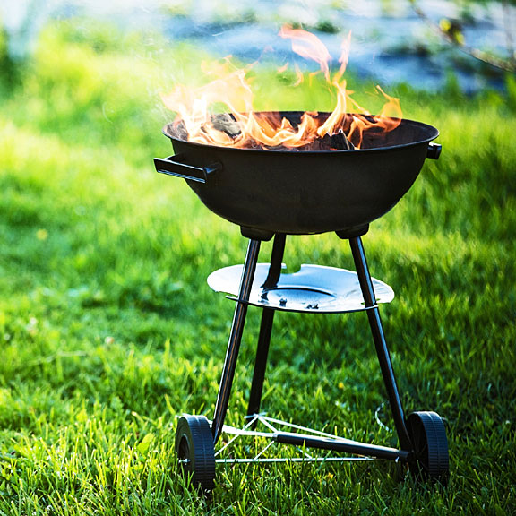 barbecue grill on a backyard lawn