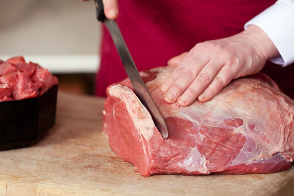 butcher cutting meat