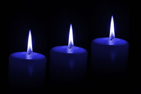 three candles on a black backgorund