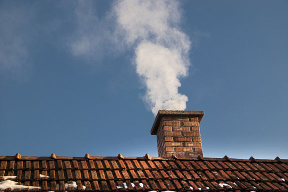 smoke pours from a chimney