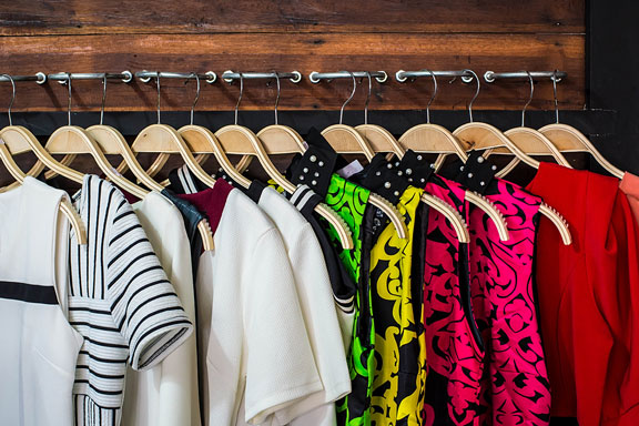 closet with blouses on hangers