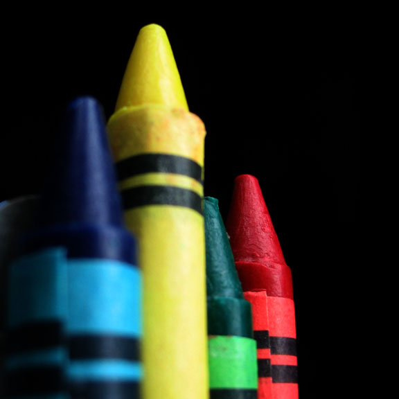 colorful crayons on black