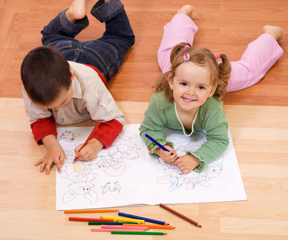 children coloring with colored pencils