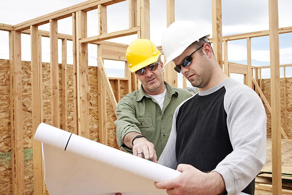 construction contractors discussing house plans