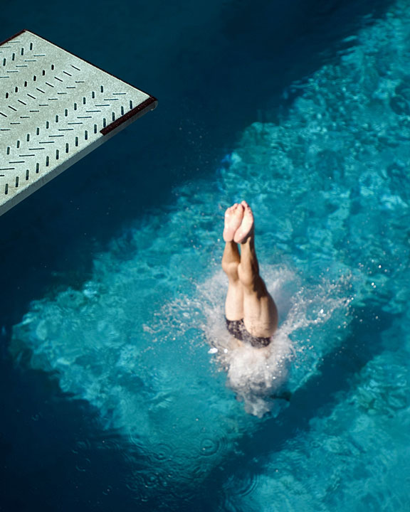 diver diving into a swimming pool