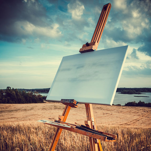 outdoor easel with canvas and paintbrushes