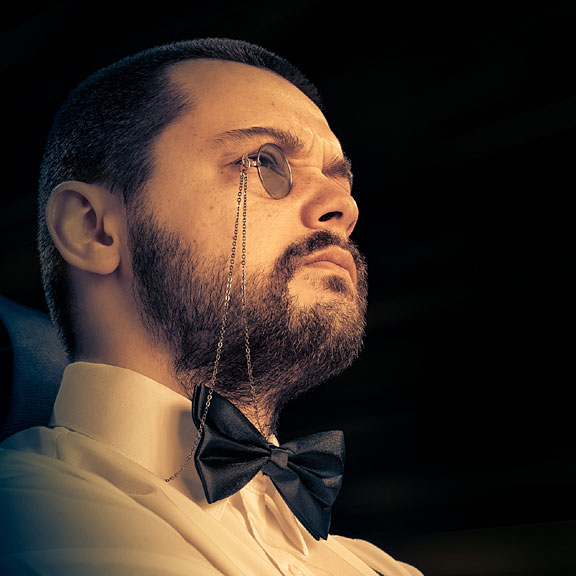 man wearing a monocle and a bowtie