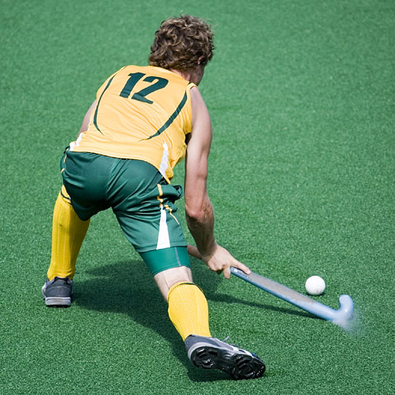 field hockey player with stick and puck