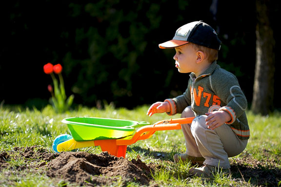 little gardener and wheelbarrow