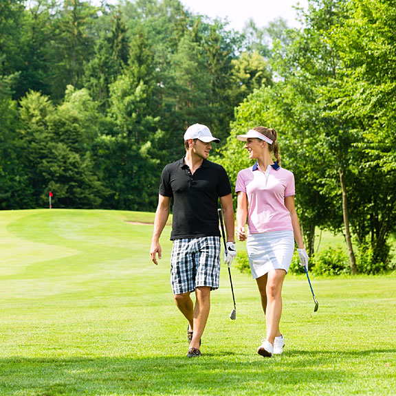 couple walking on a golf course