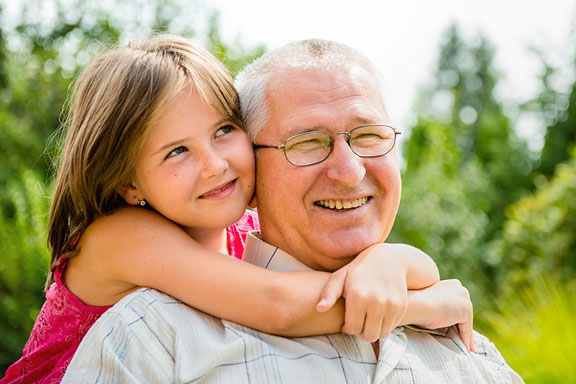 granddaughter embracing her grandfather