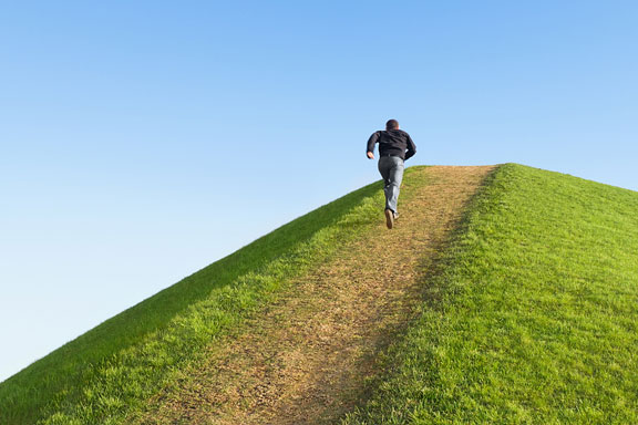 man running up a hill