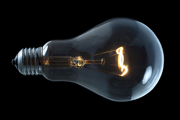 incandescent light bulb on a black background