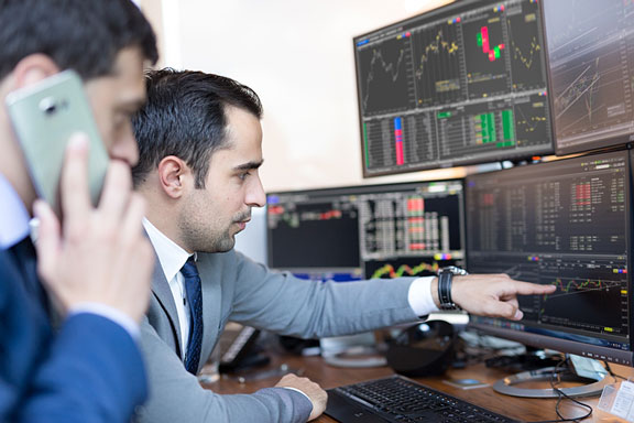 stock brokers perusing investment charts