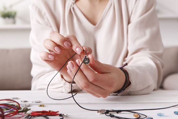 woman making jewelry at home