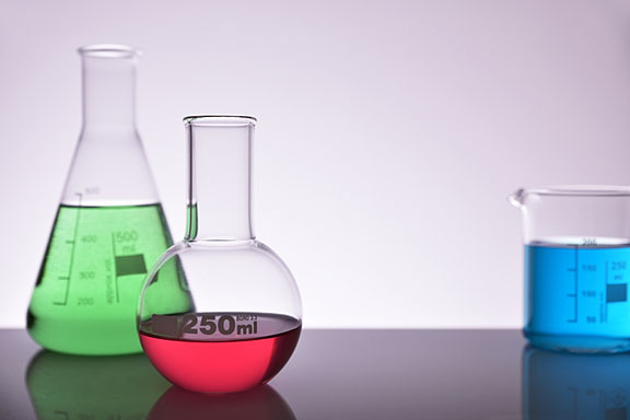 colorful chemicals in glass flasks on a laboratory table