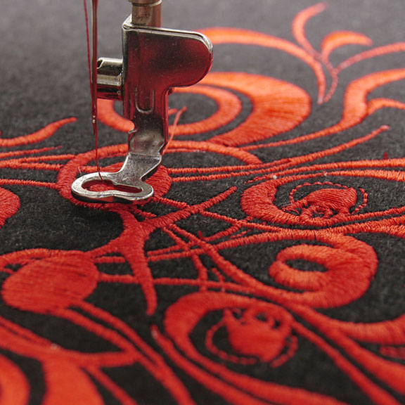 machine embroidering a red flower design