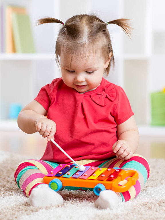 little girl playing a musical instrument