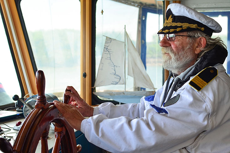 old sea captain in ship navigation cabin