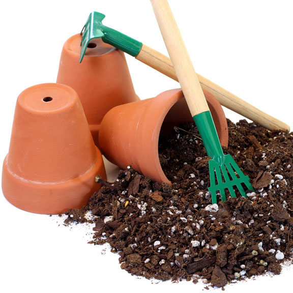 potting soil with clay pots and gardening tools