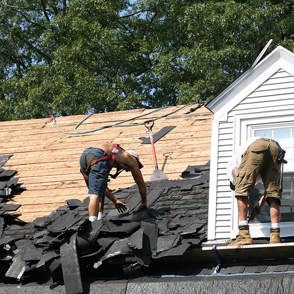 roofers working on a sloping house roof