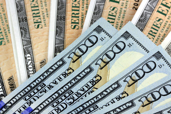 United States savings bonds and one hundred dollar bills