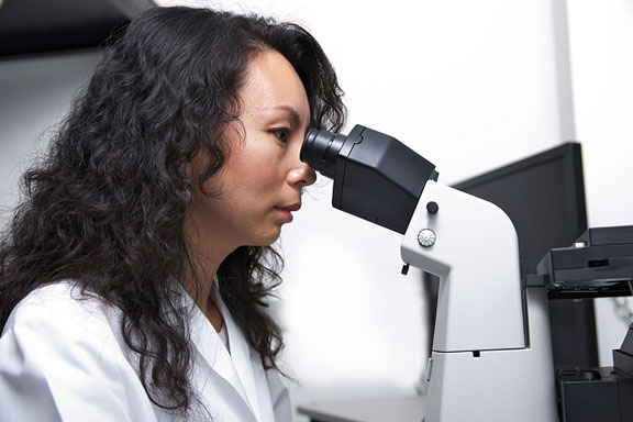 female scientist using a microscope