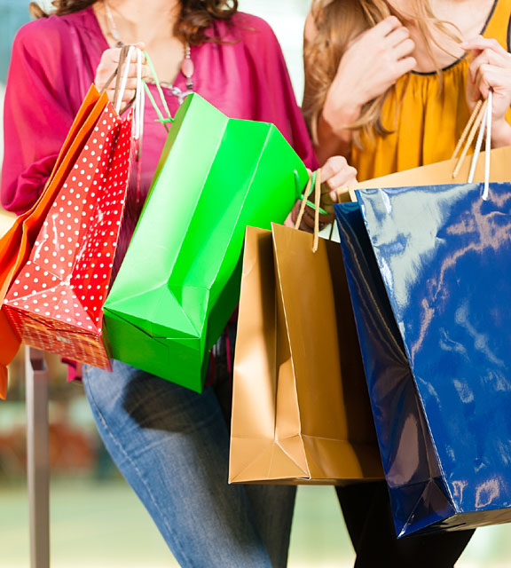 friends holding colorful shopping bags