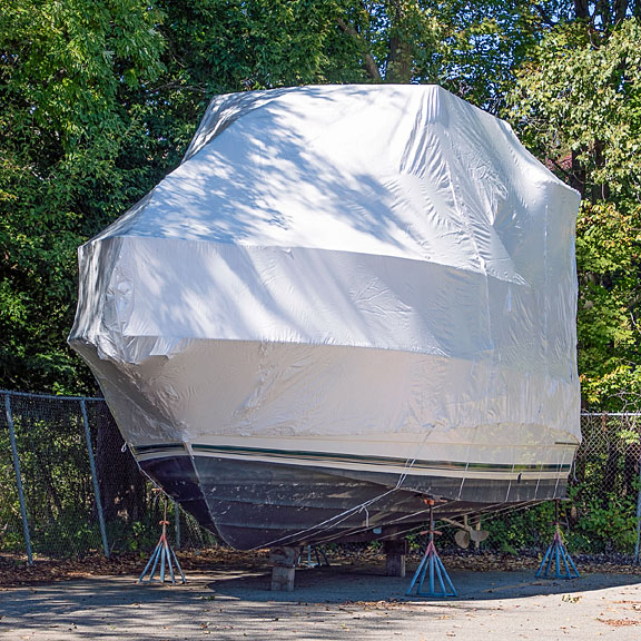 shrink-wrapped yacht on boat stands