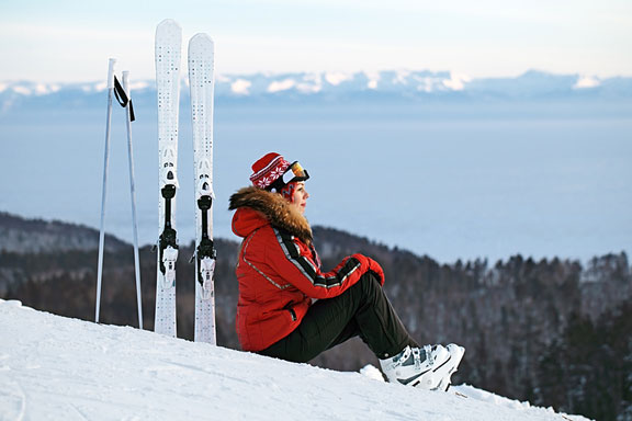 woman skier sitting on a ski slope