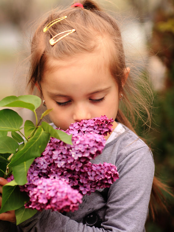 little girl smelling the flowers