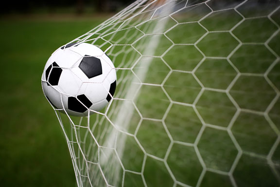 soccer ball in a soccer goal net