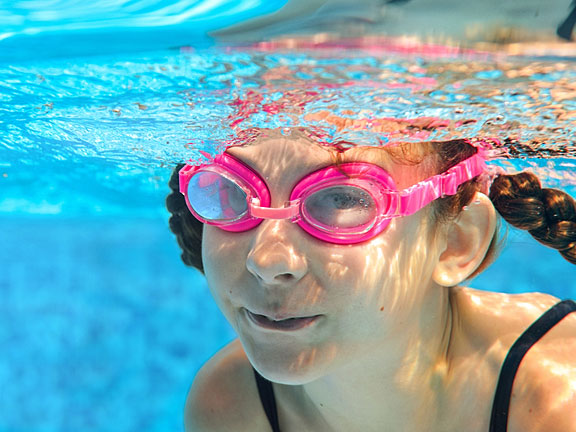 girl swimming underwater in a pool