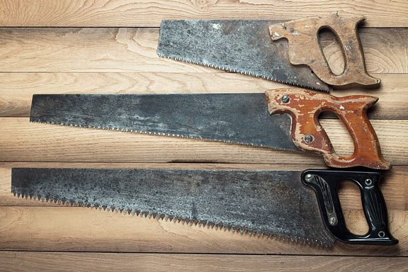 rusty hand saws on a table