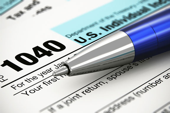 income tax form and ballpoint pen