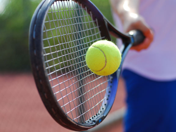 hitting a tennis ball with a tennis racket